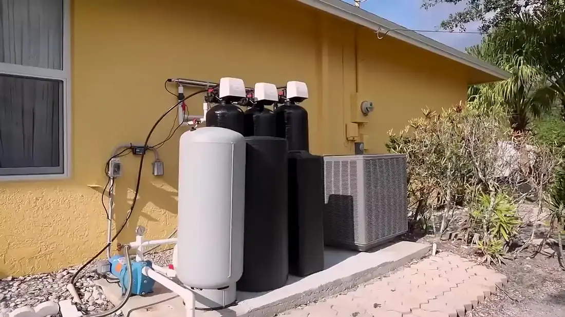Simple Water Service multi-tank well water treatment system installed under a lean-to at a western Palm Beach County home