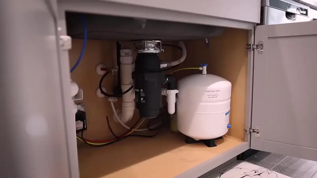 Under-sink reverse osmosis storage tank labeled Simple Water Service